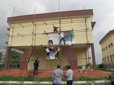 Mounting the mural painted by Brett Cook and students at the University of Lagos, 2012